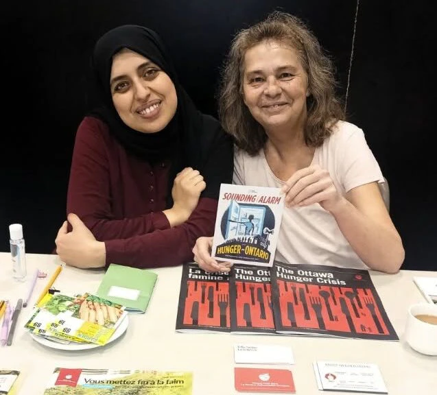 Two women sit at a table together